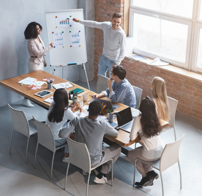 Man and black woman making business presentation to colleagues in office, new opportunities